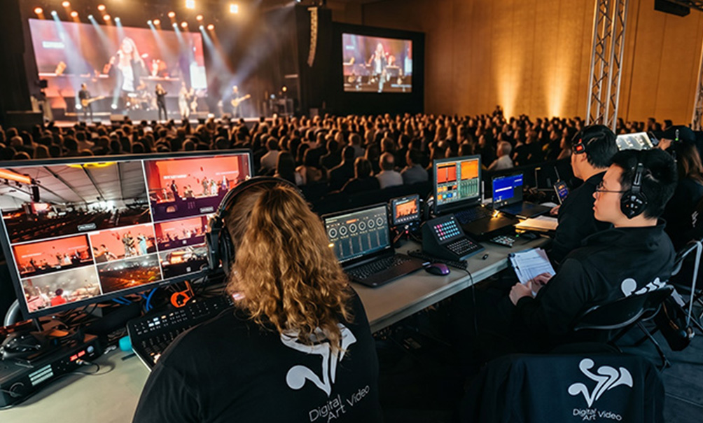 DAV Production crew operating video switching and audio equipment during a live concert