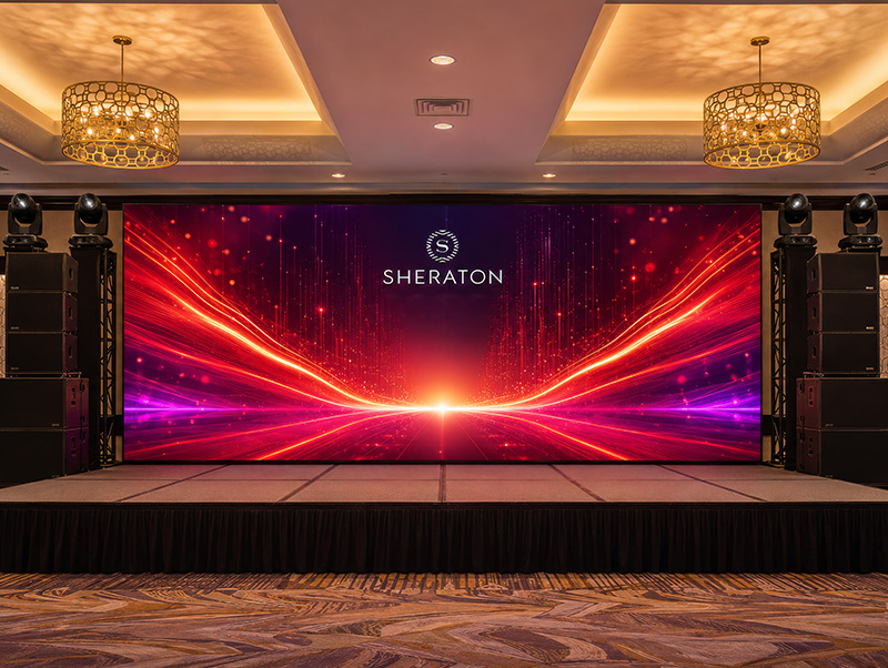 Large Sheraton-branded LED wall installed on a ballroom stage with professional speakers