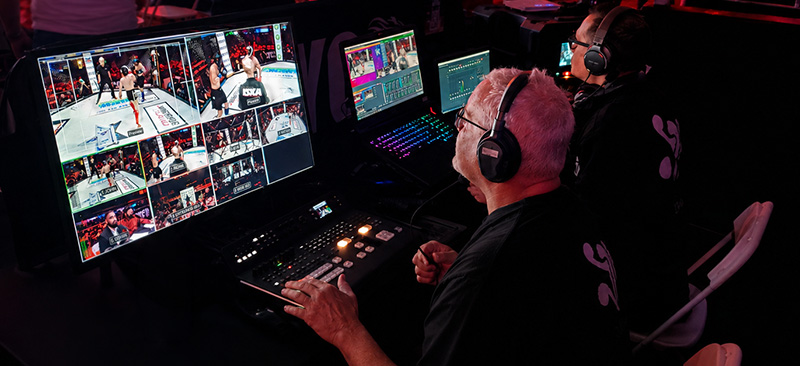 Video director switching multi-camera coverage of a live combat sports event