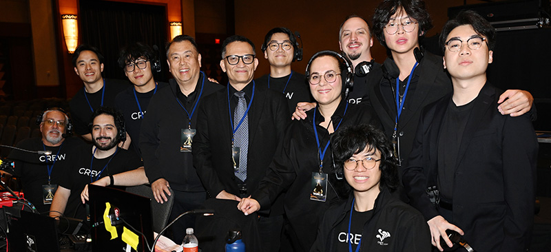 DAV Production crew posing together behind the production control station at a live event