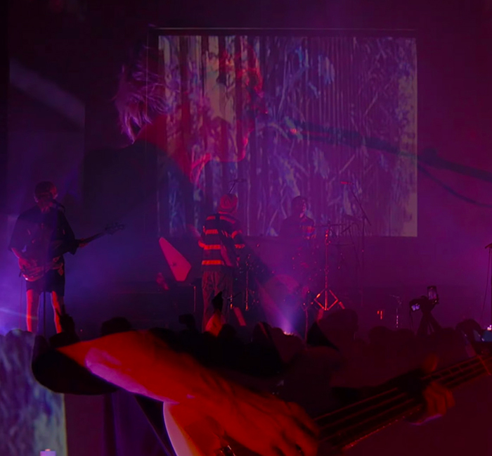 DIIV performing under red and purple stage lighting at Brooklyn Steel