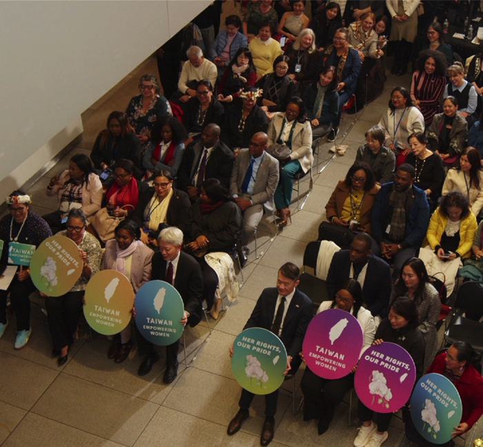 Guests holding Taiwan women’s empowerment signs during Taiwan Gender Equality Week