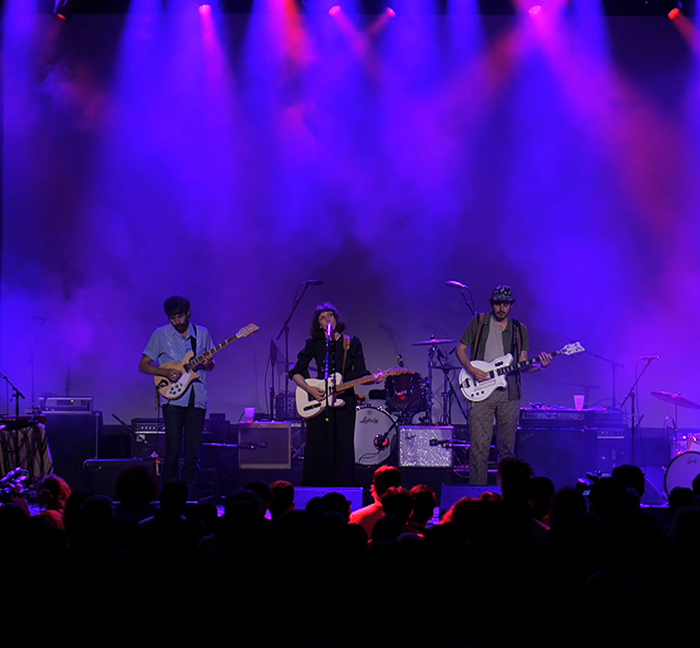 Widowspeak performing under purple stage lighting at Brooklyn Steel
